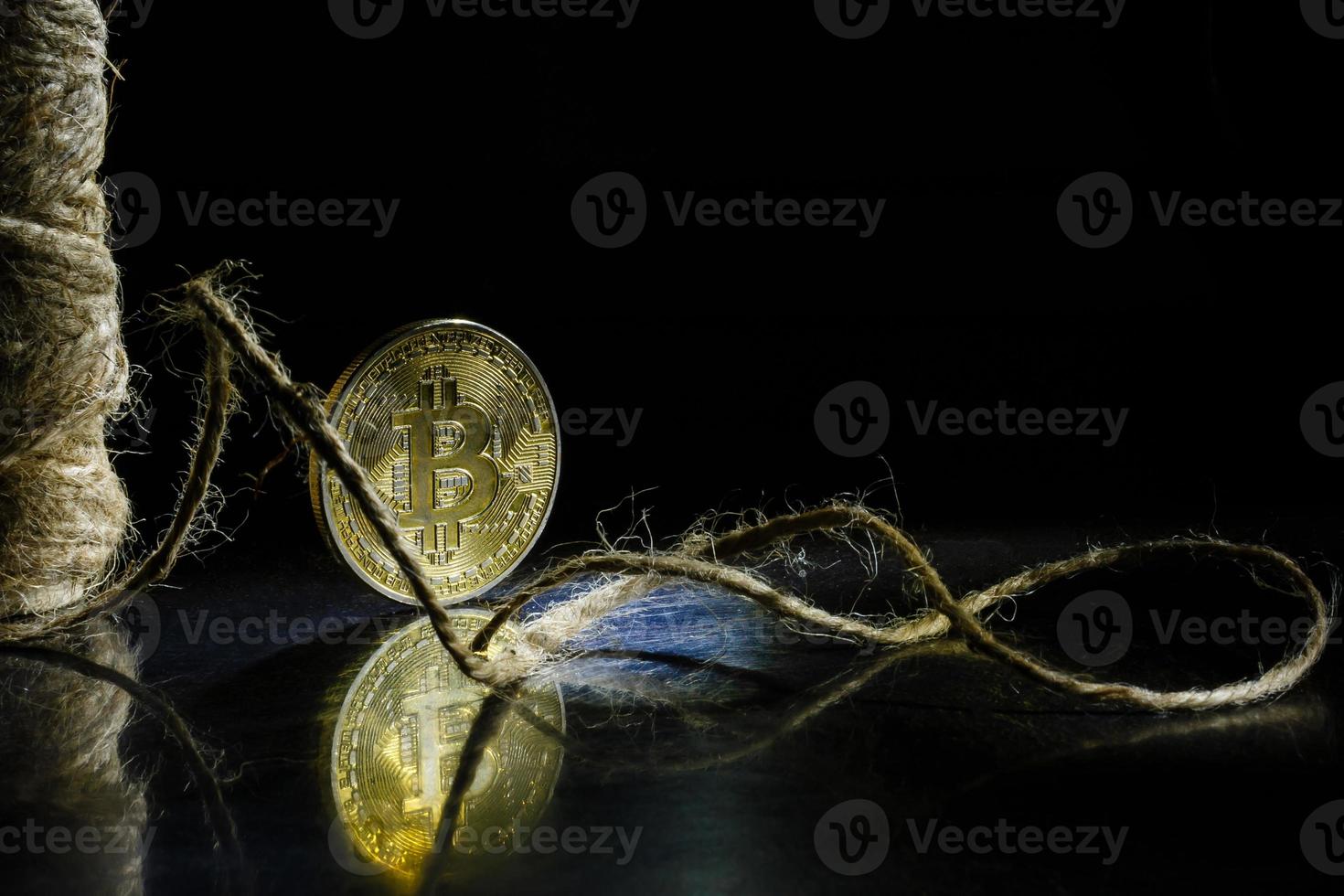 Golden bitcoin on black background with copy space cryptocurrency mining concept photo