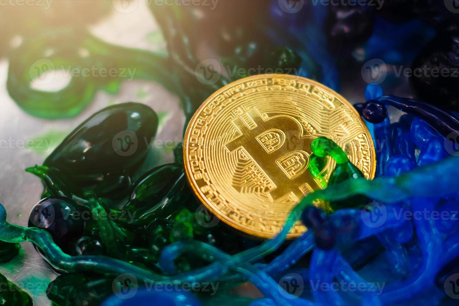 Cryptocurrency physical gold bitcoin coin and  colorful sweets photo