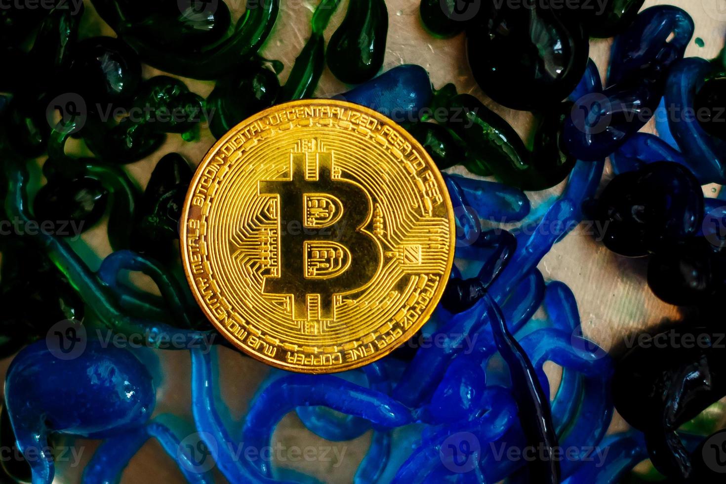 Cryptocurrency physical gold bitcoin coin and  colorful sweets photo