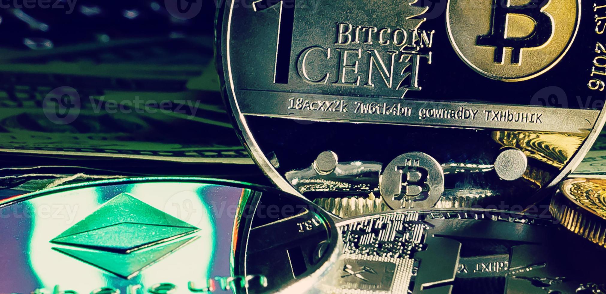 silver bitcoin on one hundred dollar bills photo