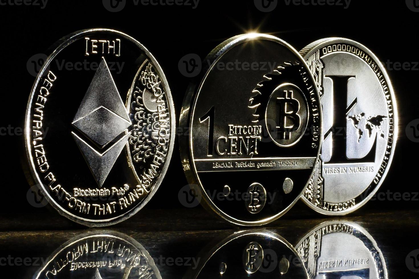 Cryptocurrencys ethereum bitcoin litecoin and mound of gold business concept image photo