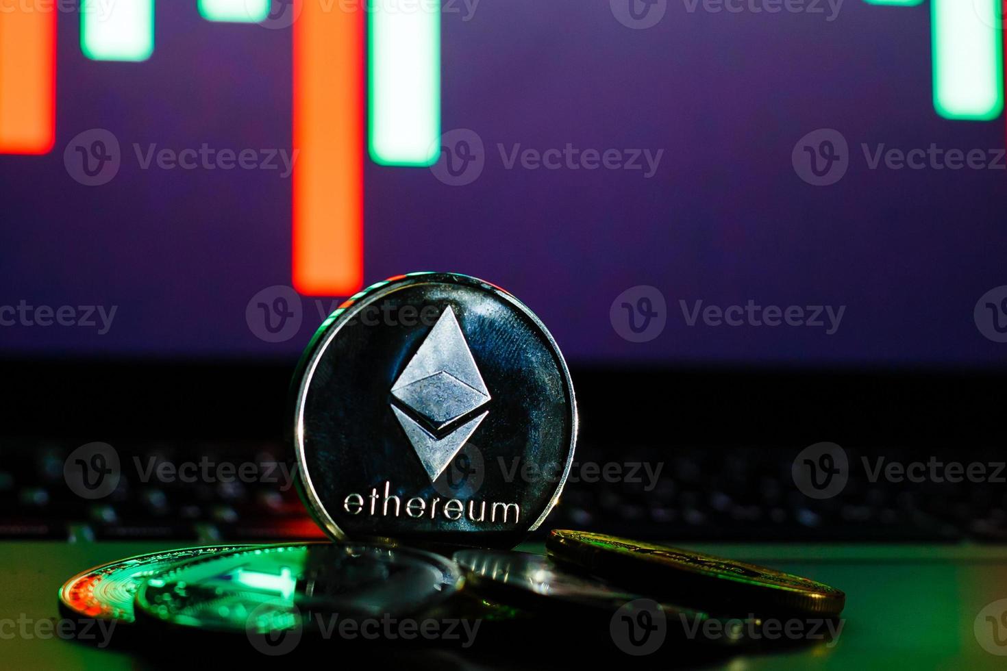 Digital currency physical ethereum coins on black computer keyboard photo