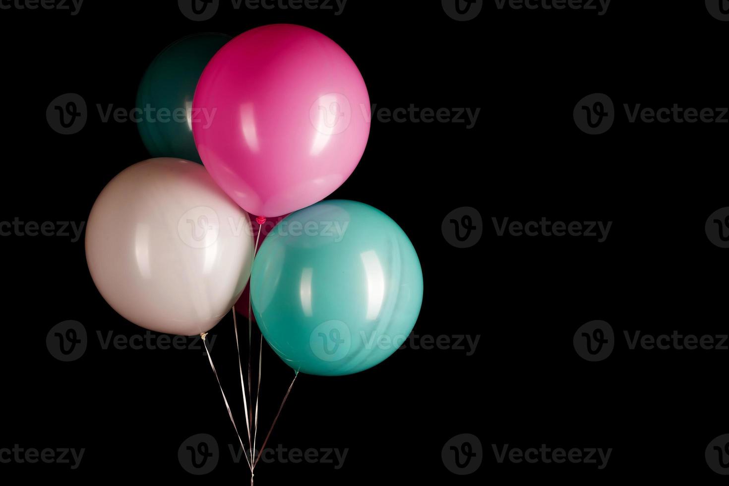 white blue pink balloons on a black background photo