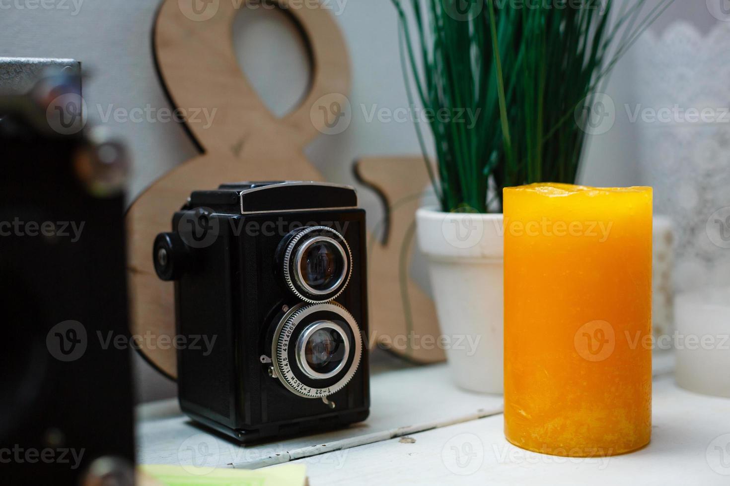 Old camera and stack of vintage books photo