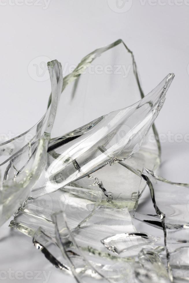 Broken glass bottle. Sharp shards of clear glass. photo
