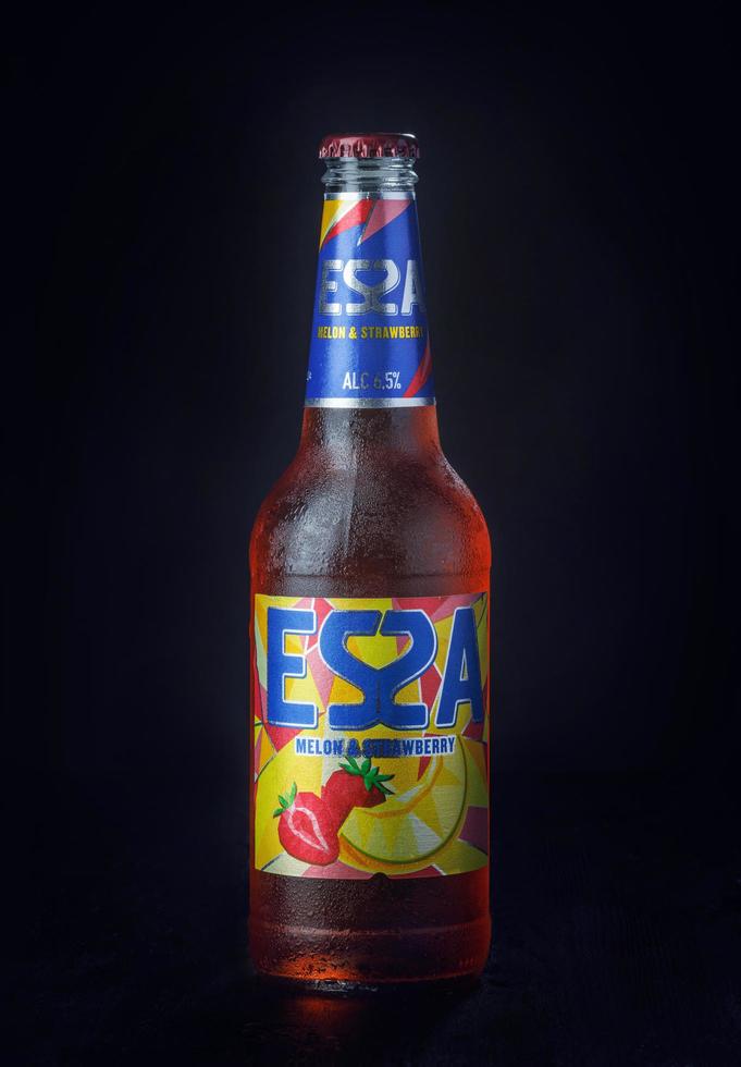 KRASNOYARSK, RUSSIA - OCTOBER 21, 2022 Misted bottle of ESSA beer on a black background. Fruit beer. photo