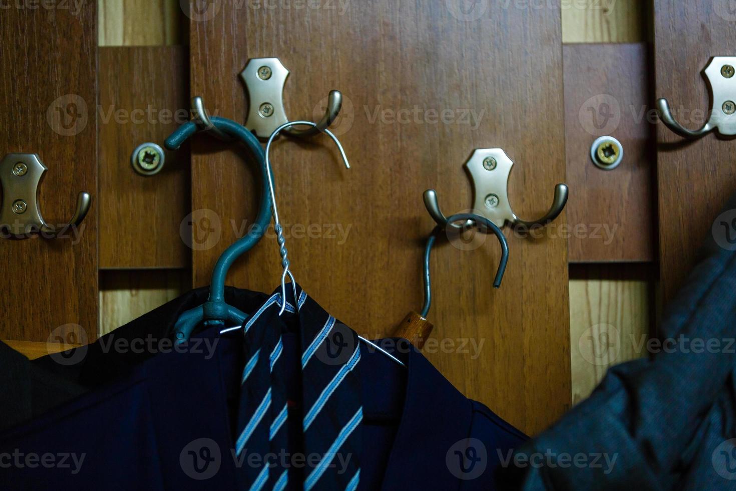 Close up view of man clothes hang in clothes store. Hangers with different male clothes. Copy space. Selective focus. Toned image photo