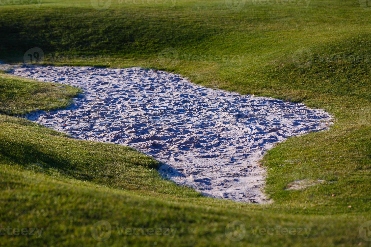 Sand bunker on the golf course photo