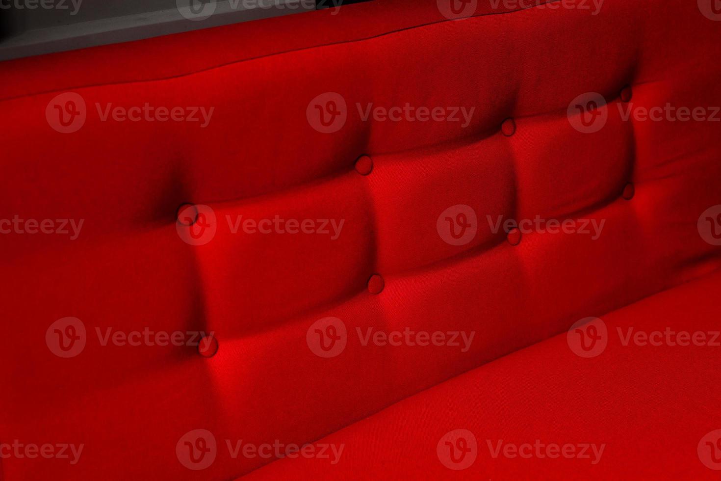 Closeup of a red cushion with buttons photo