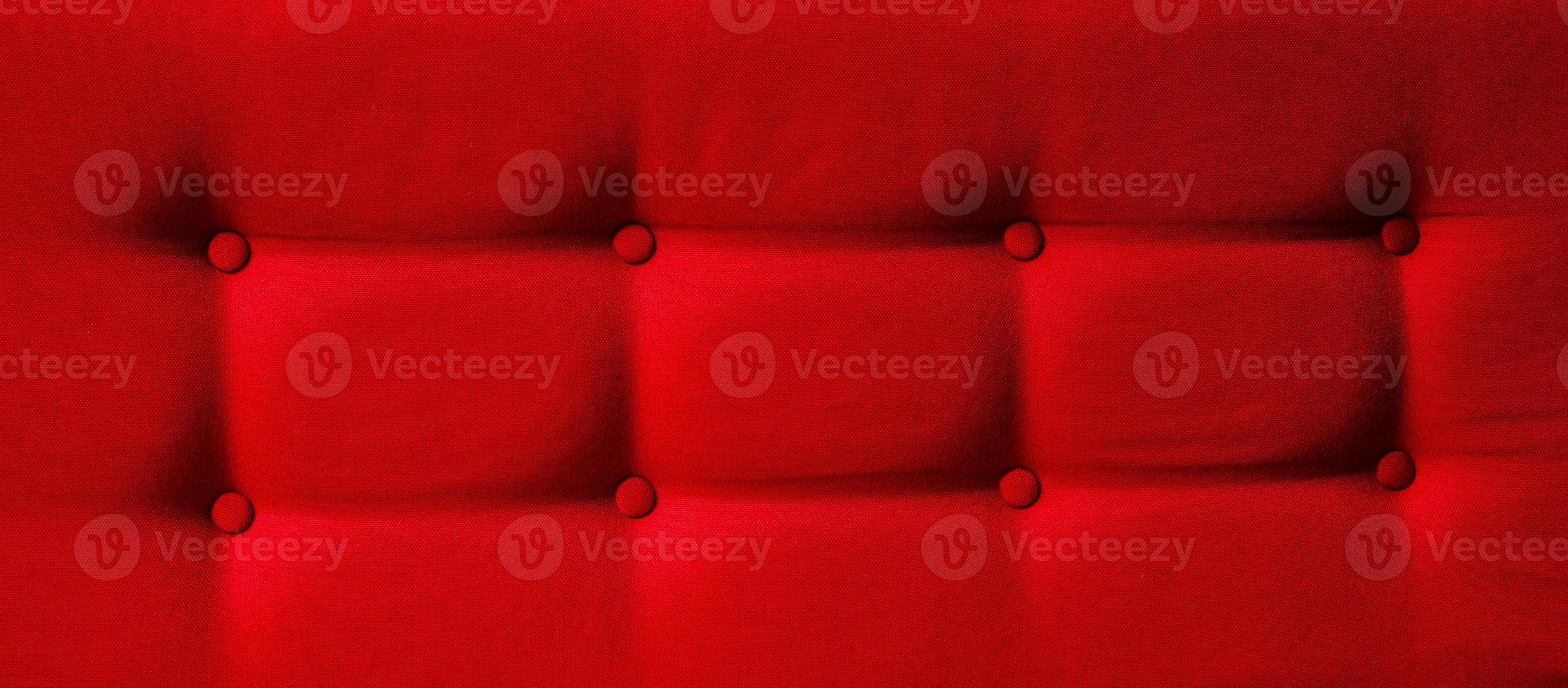Closeup of a red cushion with buttons photo
