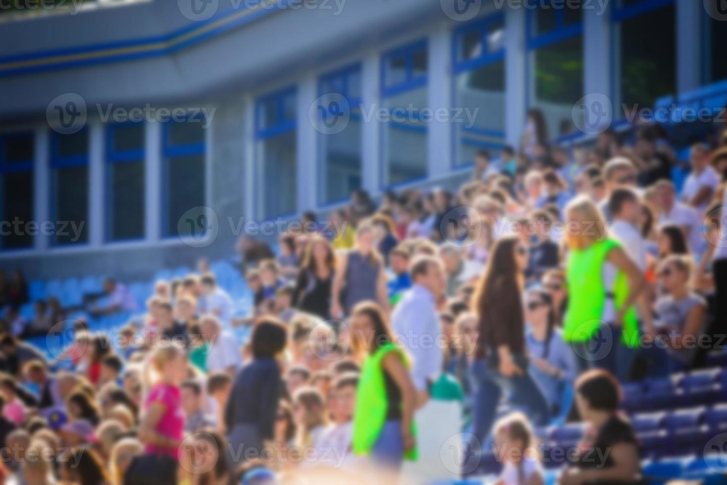 Defocused background of crowd of people photo