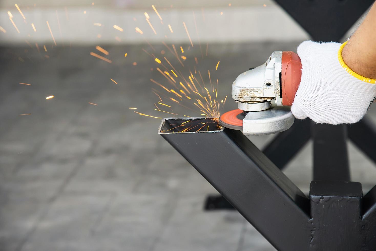 Man doing metal work using hand cutting machine tool photo