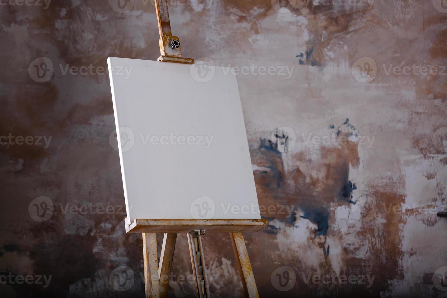 White empty artistic canvas on an easel for drawing images by an artist on a gray background photo