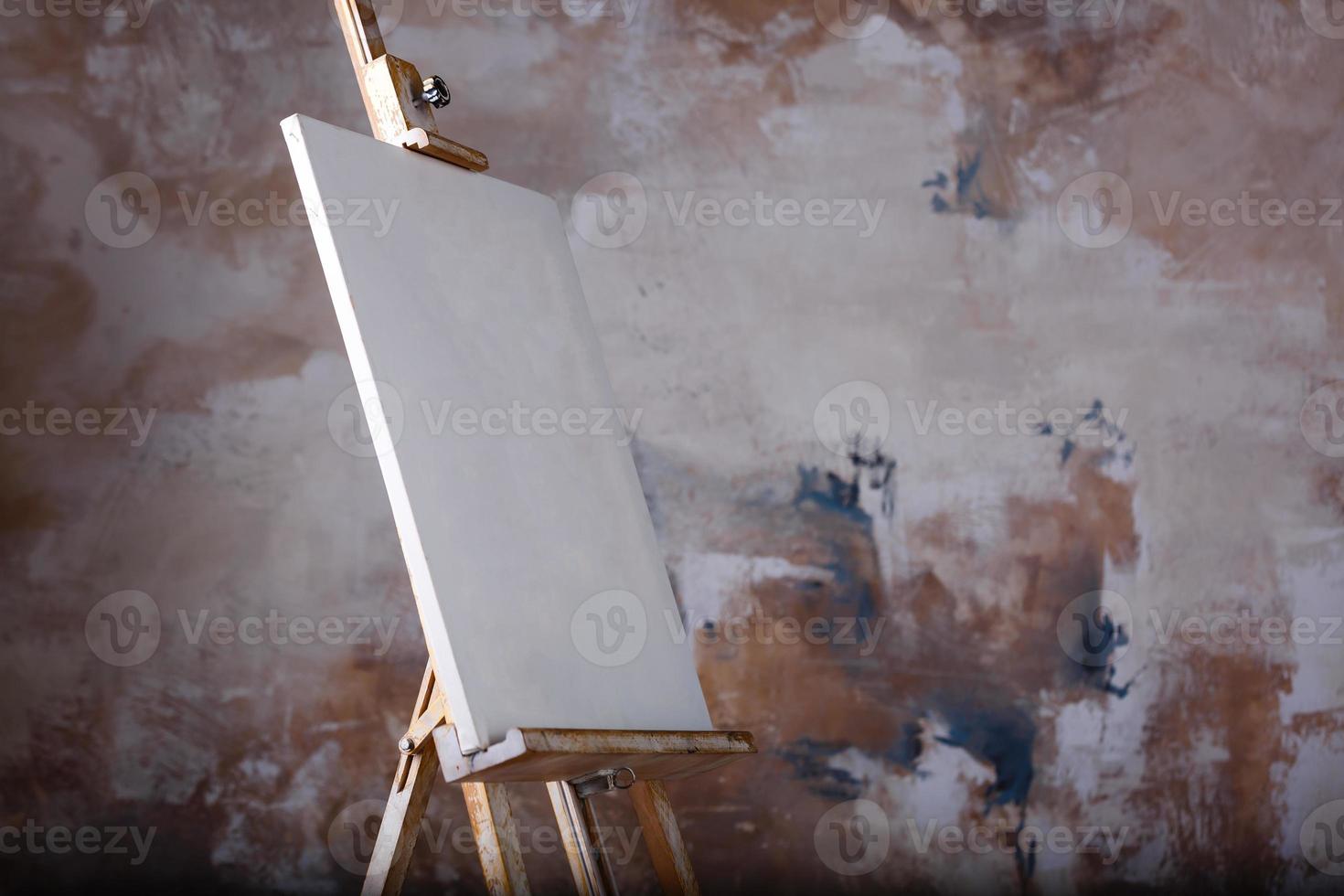 White empty artistic canvas on an easel for drawing images by an artist on a gray background photo