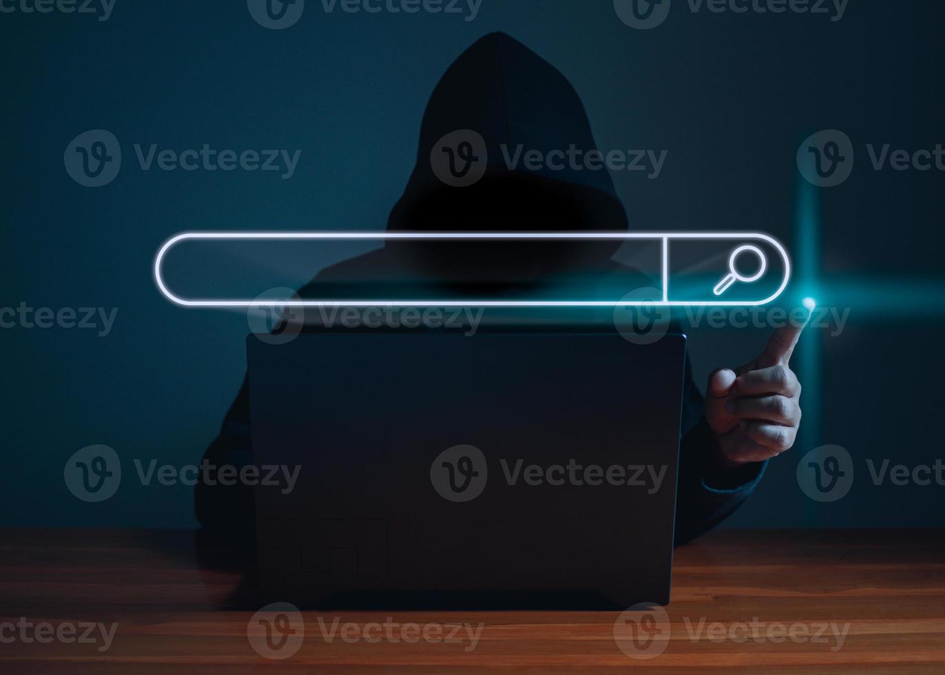 Hackers work on laptops in the dark. The concept of information security in the Internet network and information espionage. photo