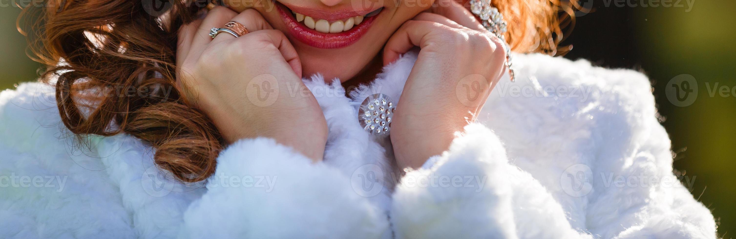 Lips and bride s hand with a ring with pebbles and manicure photo
