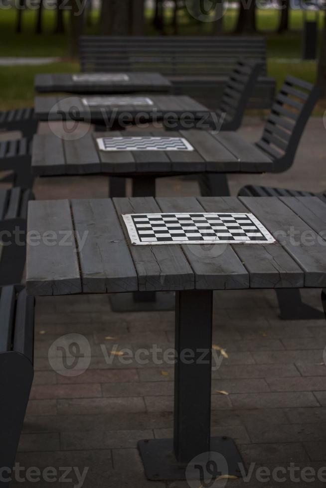 There are chess tables for everyone in the park. City playgrounds. photo