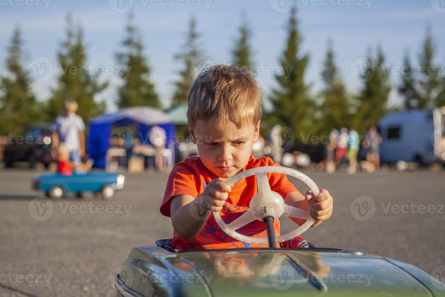 A boy driving a children's car. Joyful emotions. Children, portrait. photo