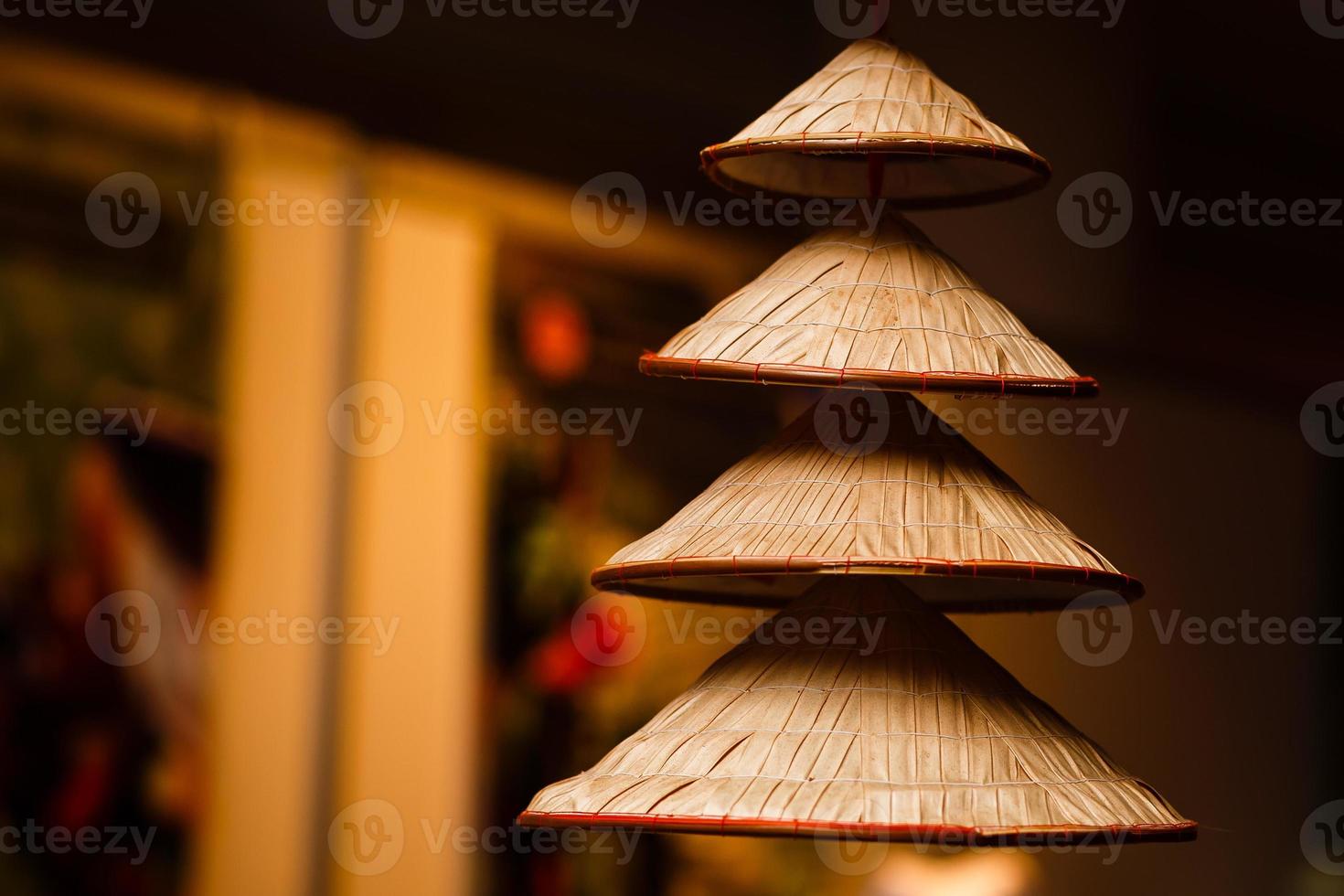 Vietnamese traditional conical hats hanging on wire for decoration. photo