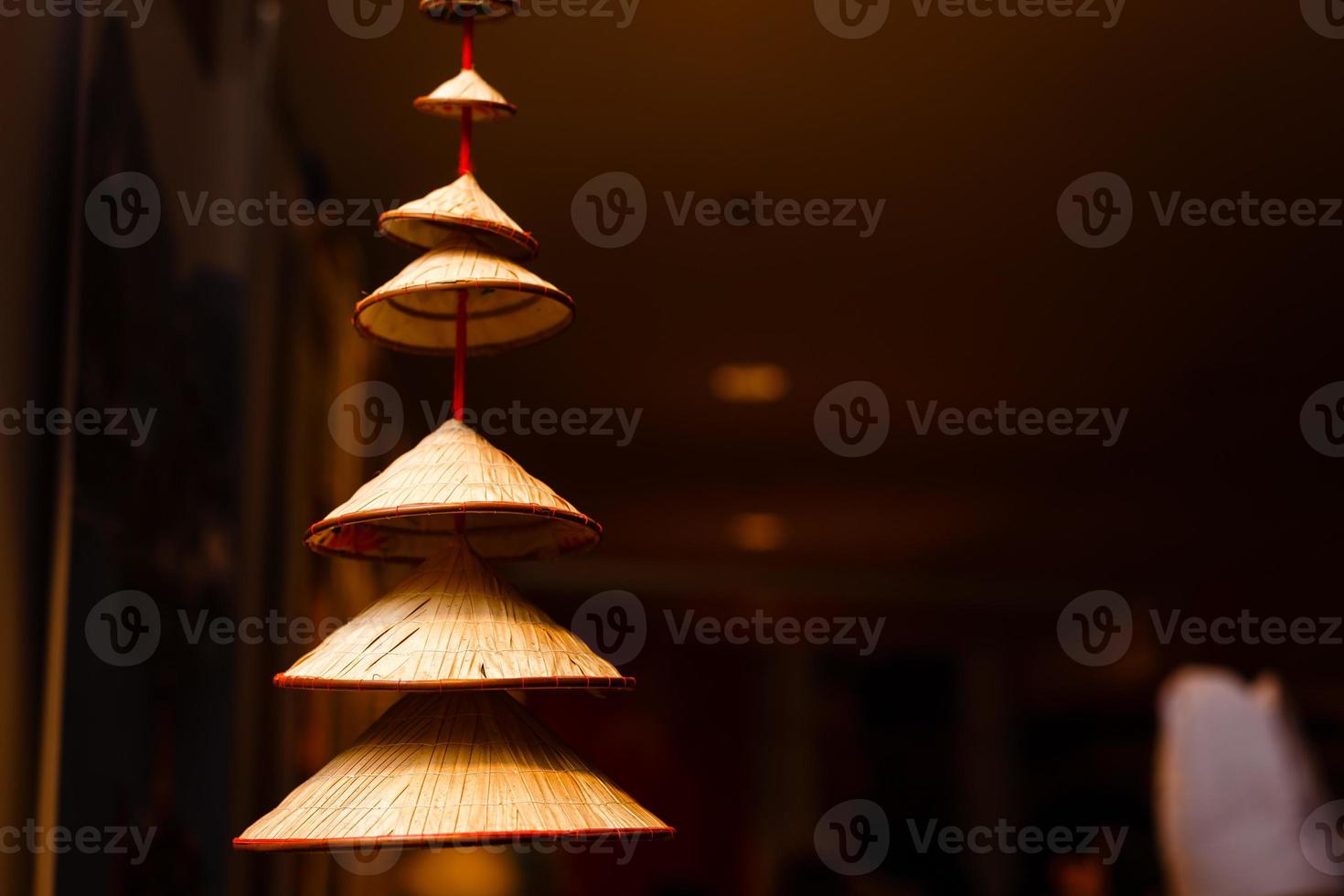 Vietnamese traditional conical hats hanging on wire for decoration. photo