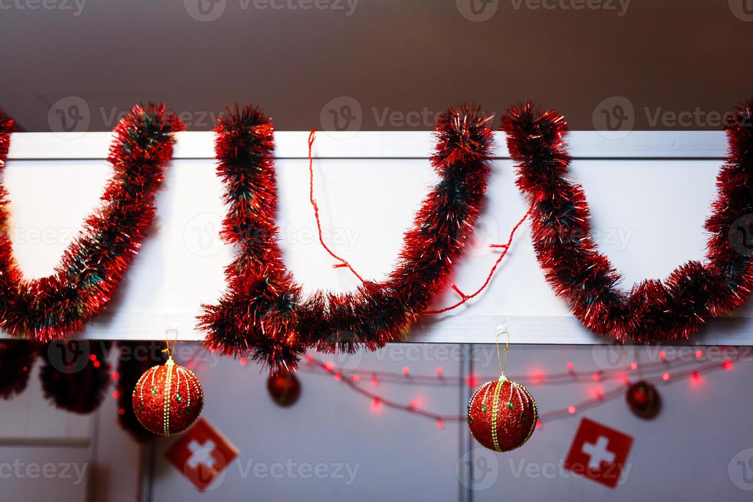 Fir branch with balls and festive lights on the Christmas background with sparkles. photo
