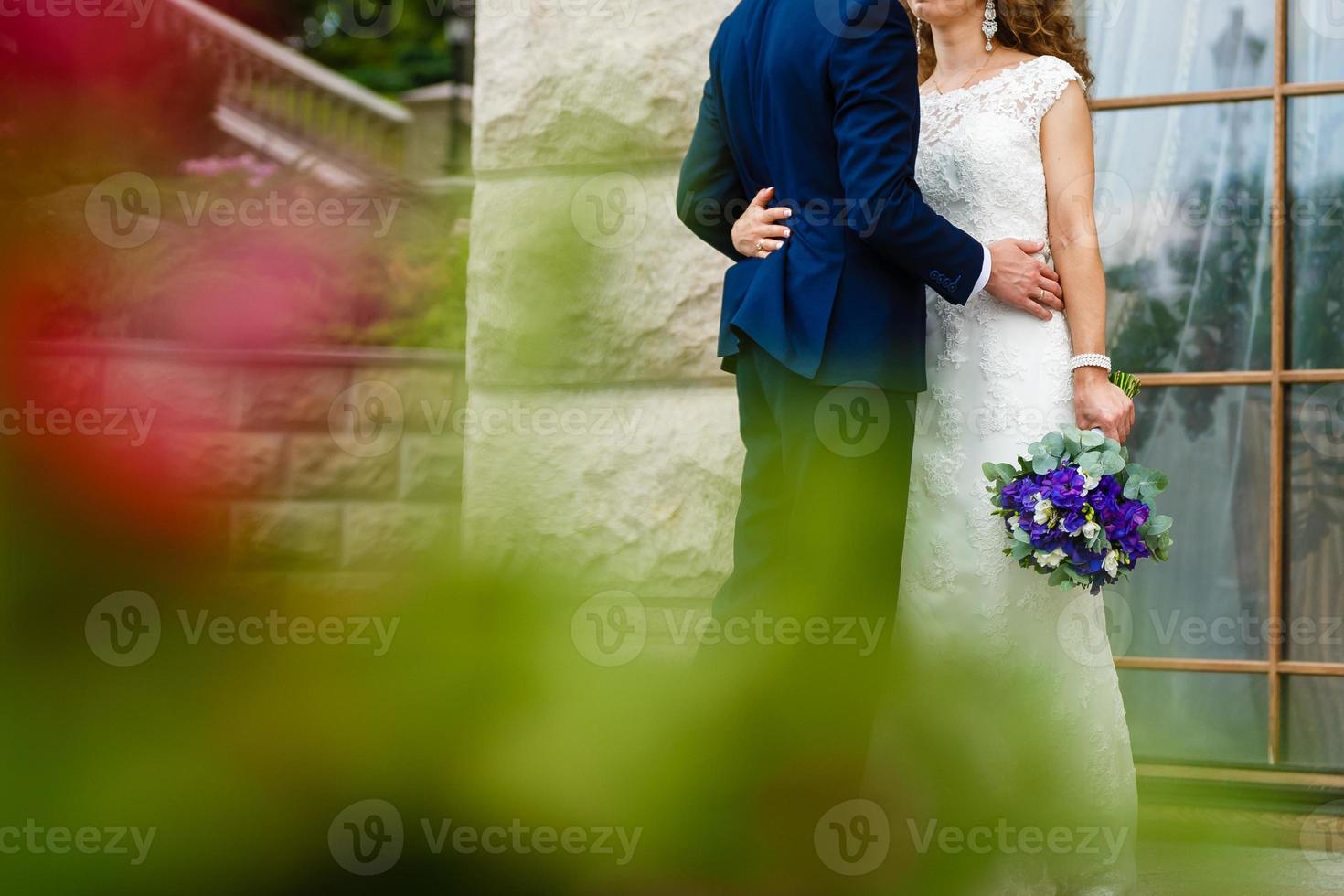 Close up of groom s hand holding bride s wirst tender photo