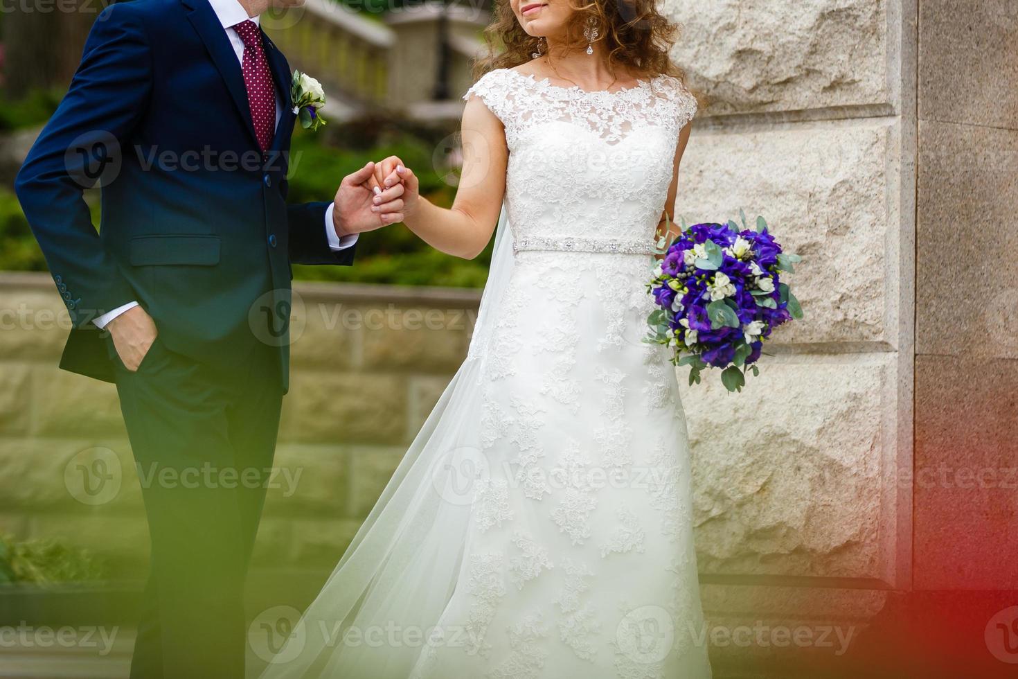 Young bride and groom in the park a wedding bouquet wedding dresses photo