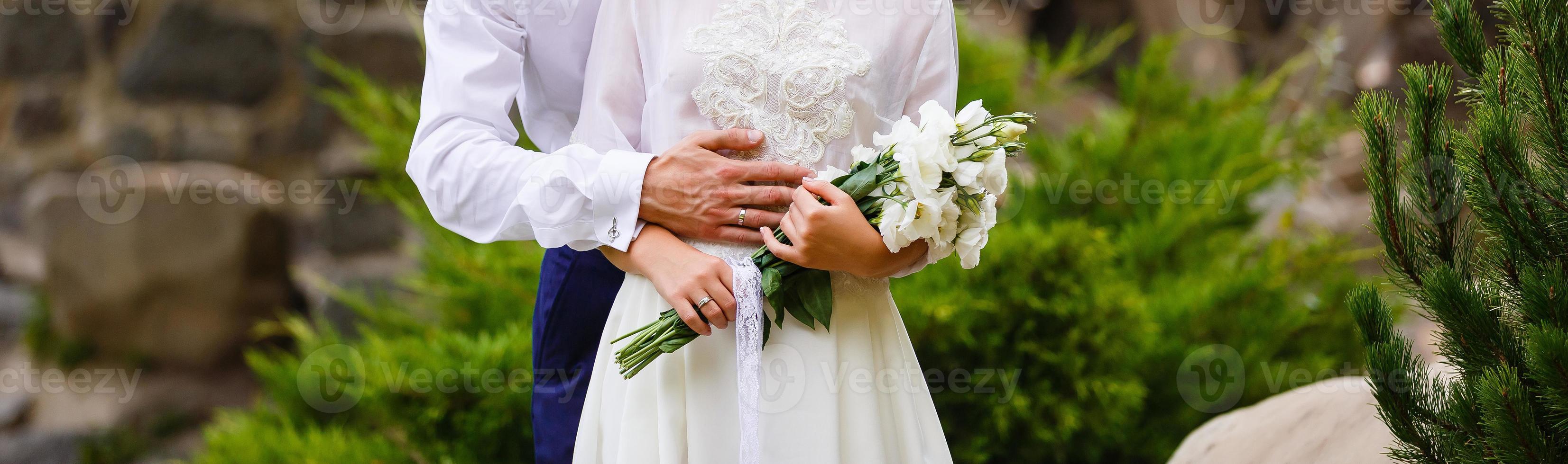 Newlyweds groom and bride walking in autumn park photo