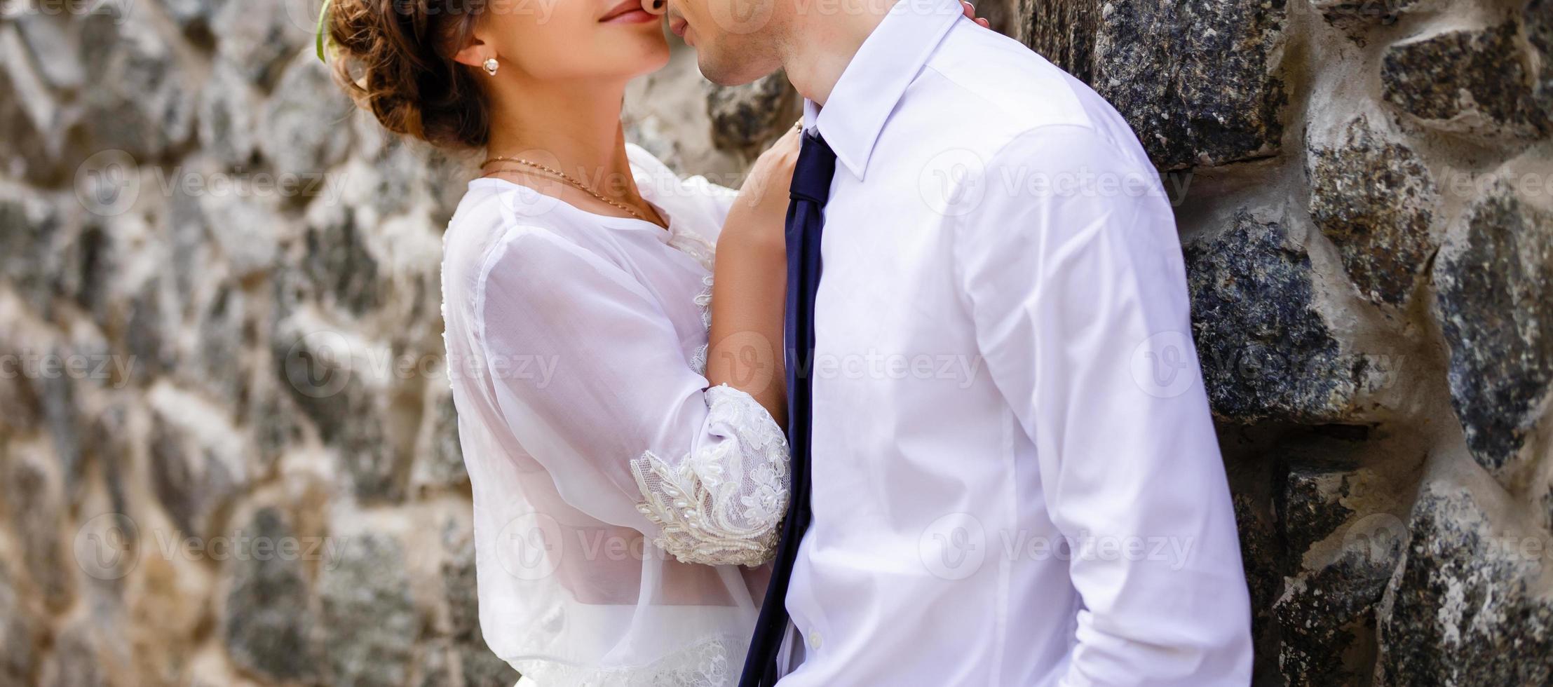 The bride and groom on the background of a mountain stream photo