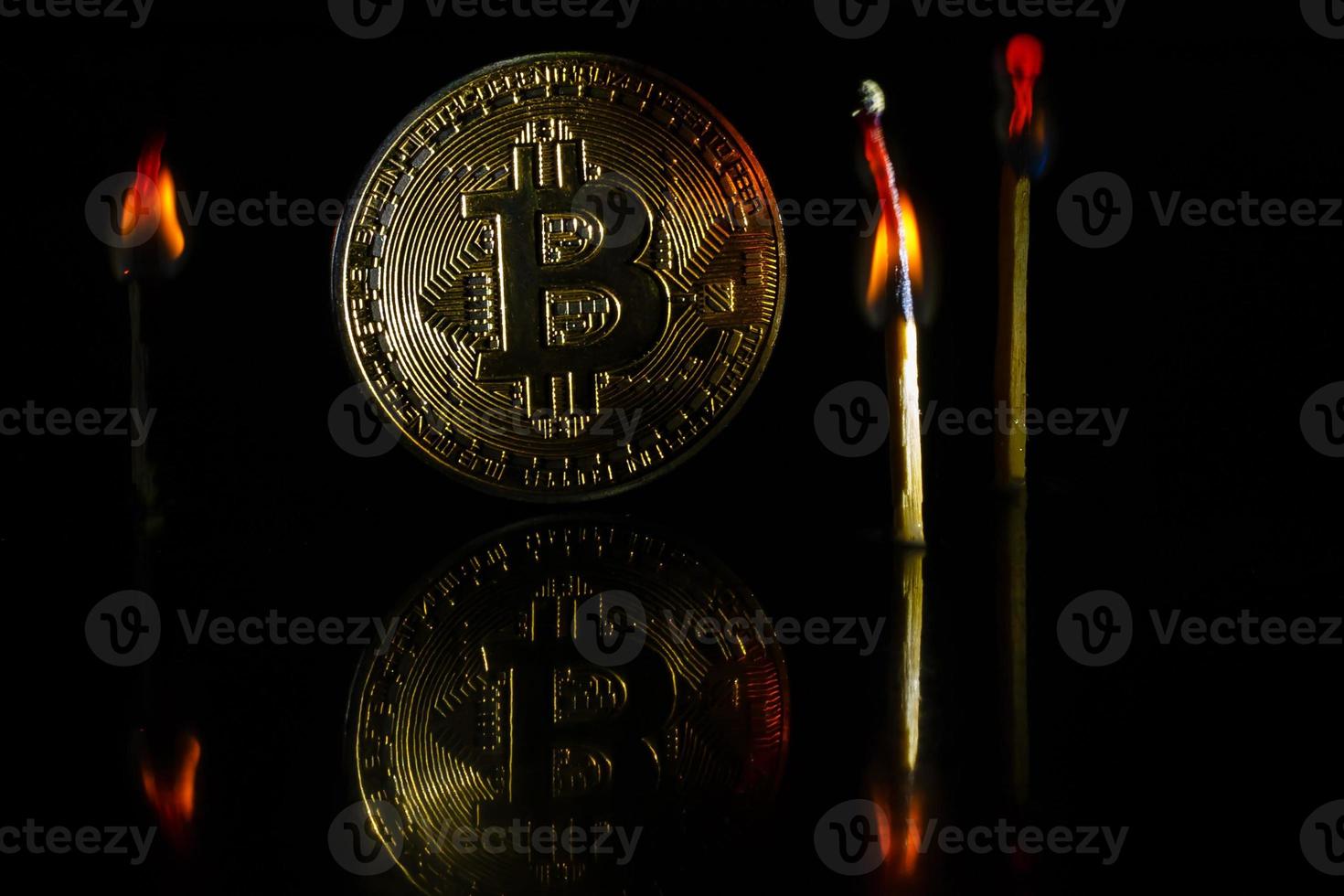 Golden bitcoin on black background with copy space cryptocurrency mining concept burns photo