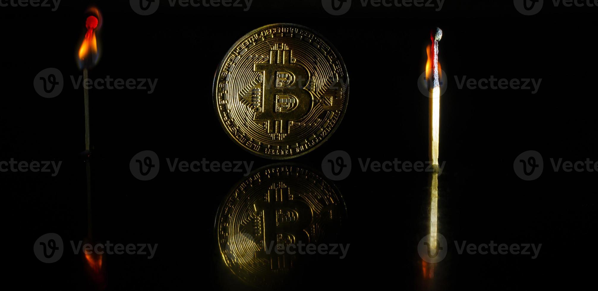 Golden bitcoin on black background with copy space cryptocurrency mining concept burns photo