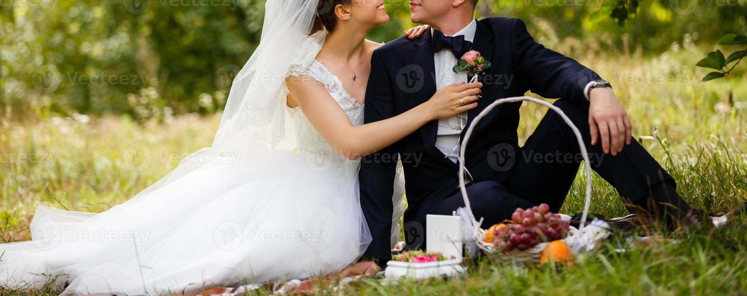 Happy bride and groom at a park on their wedding day photo