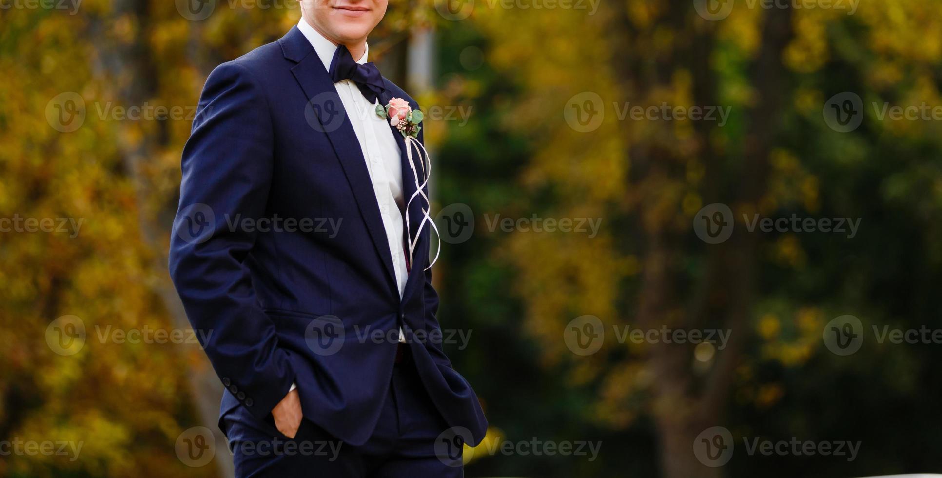 Handsome groom in suit  the nature male portrait  the park beautiful model boy  colorful photo