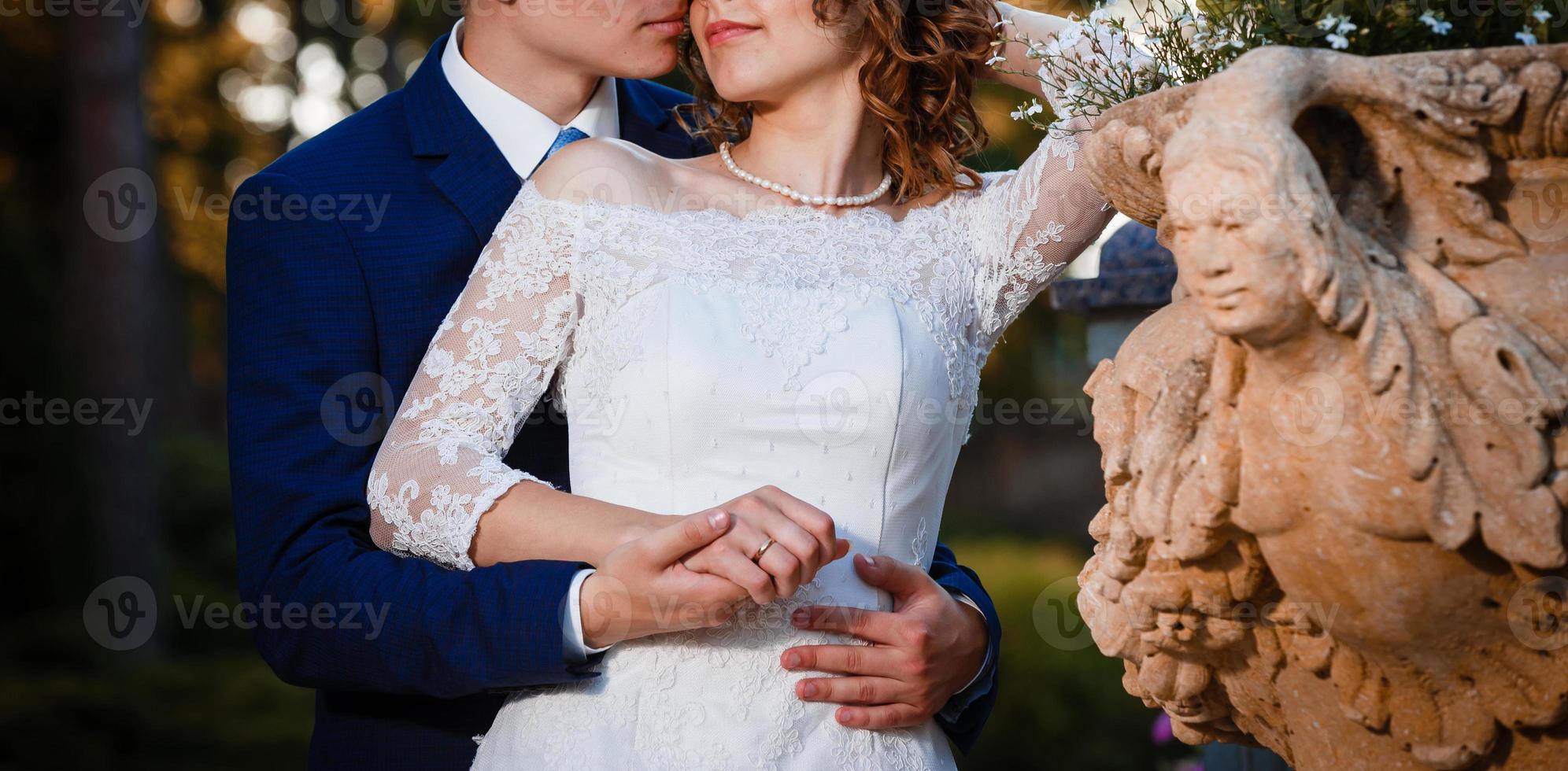 Happy bride and groom at a park on their wedding day photo