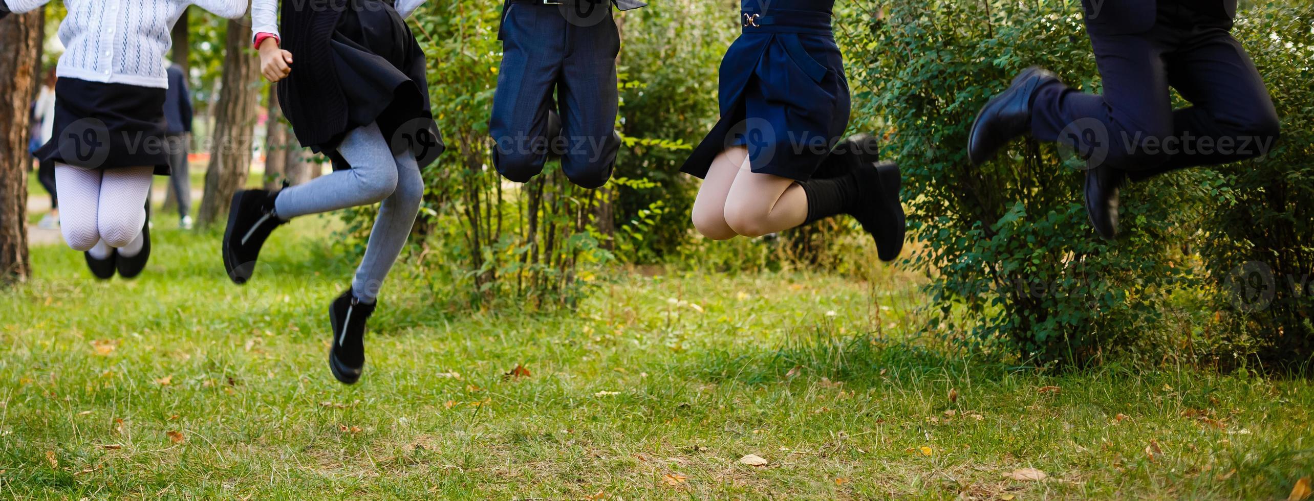 Kids jumping in a orchard summer day photo