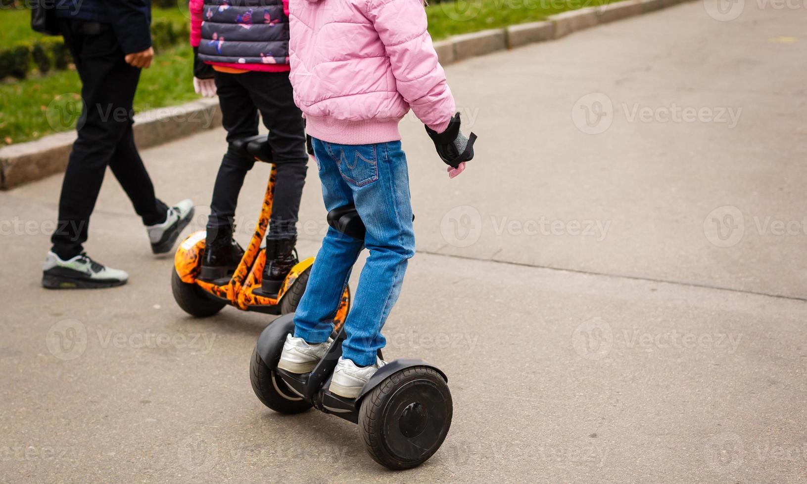 Young woman riding hoverboard electrical scooter personal eco transport new modern photo