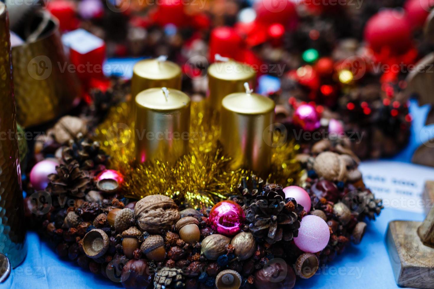 Christmas decorations, candle, nuts, cones, cinnamon, apples, star on a wooden background. Holiday mood. photo