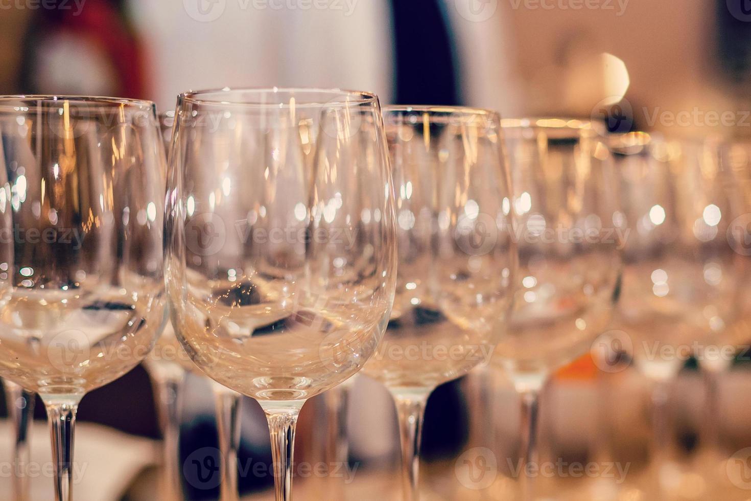 Wine glasses in row on bar photo