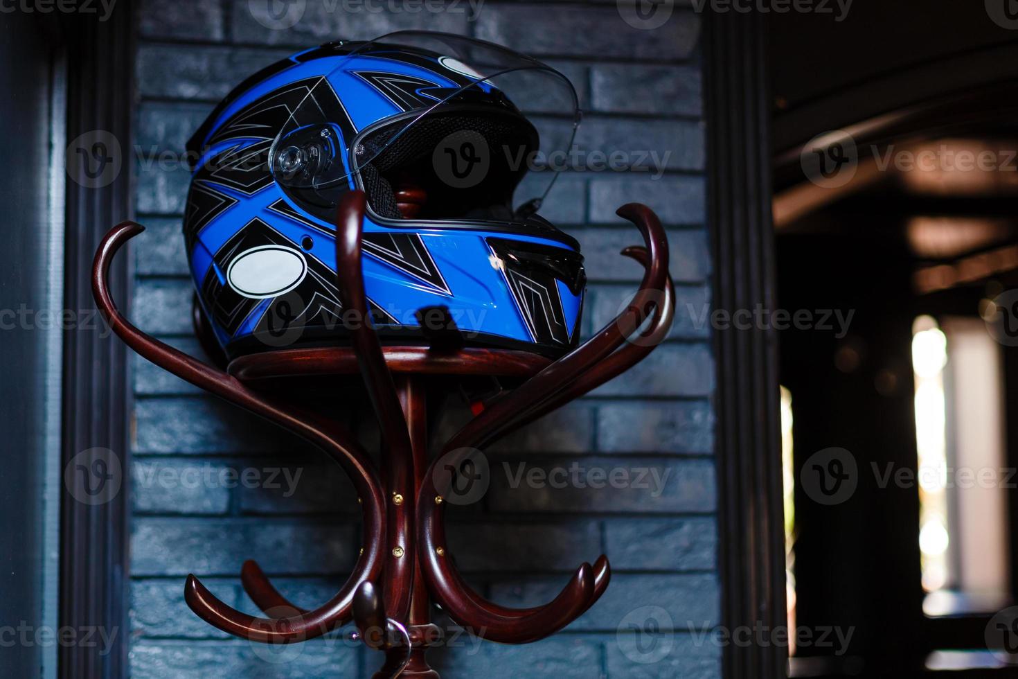 motorcycle helmet rests on a hanger photo