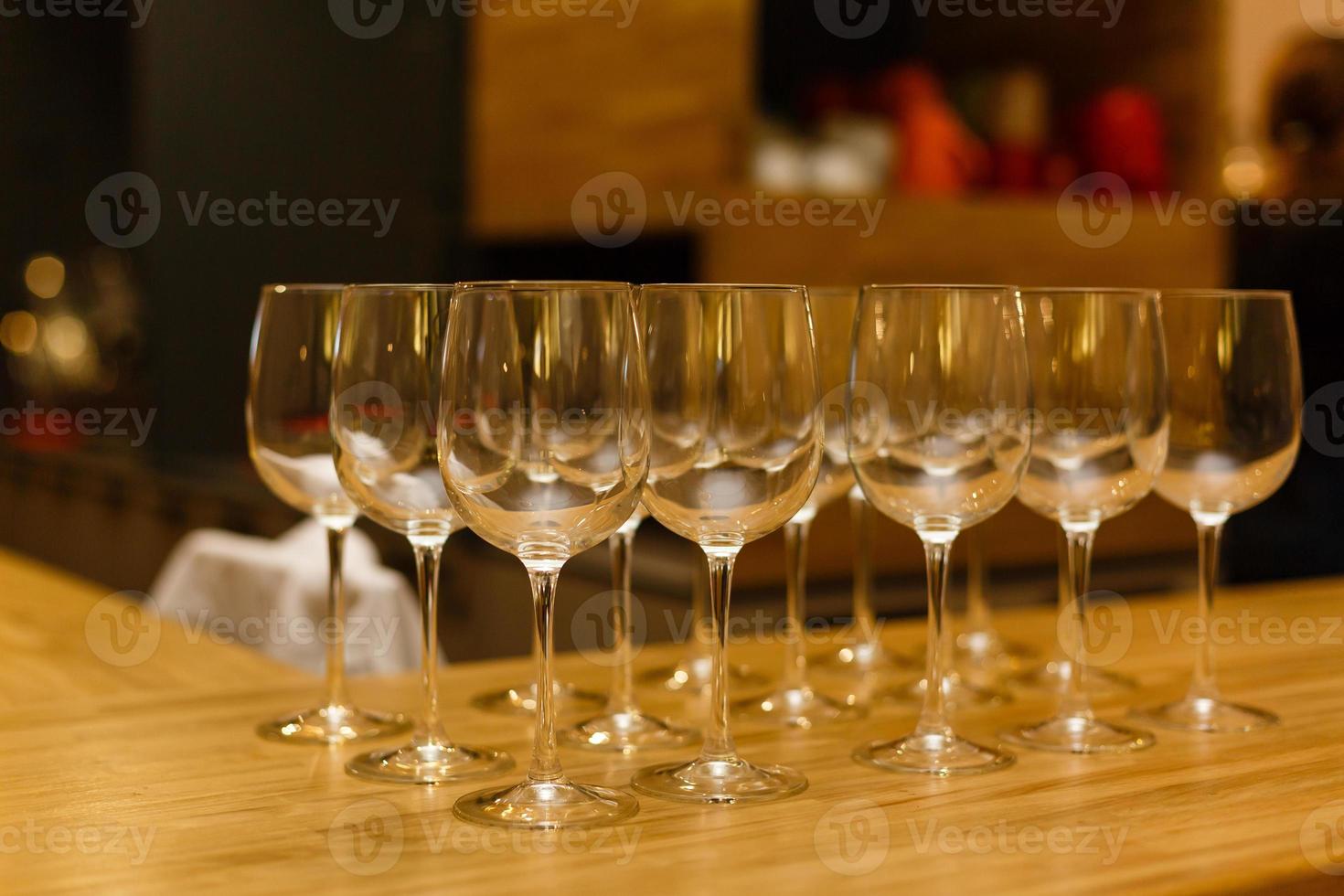 Wine glasses in row on bar photo