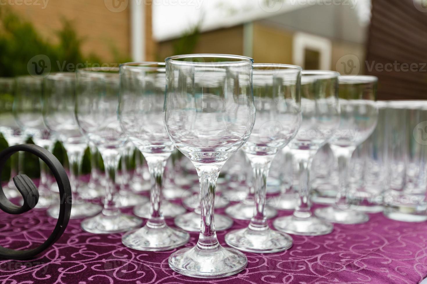 Beautiful champagne glasses defocused on buffet table in restaurant and blurred background photo