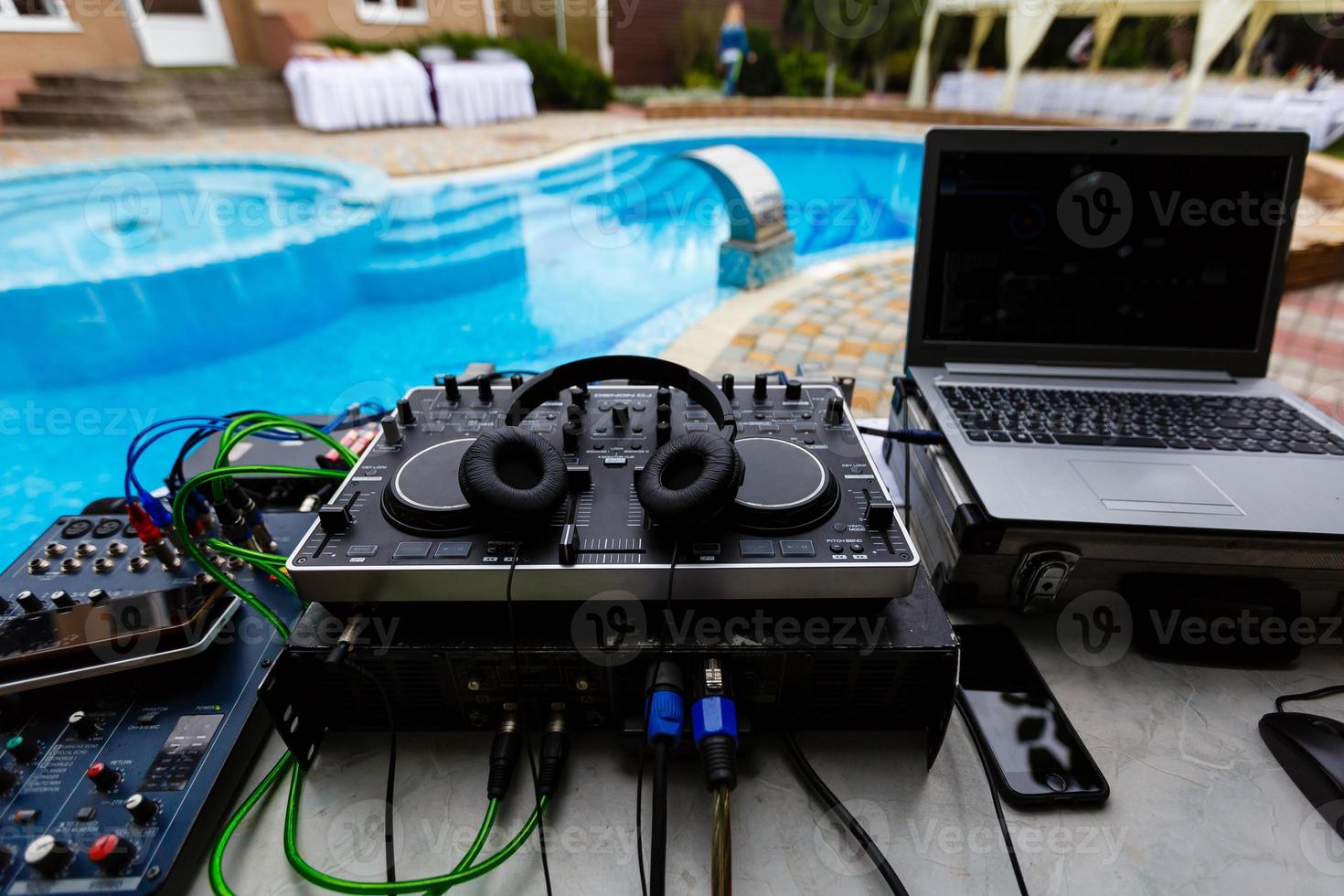 DJ console on a background of a swimming pool photo