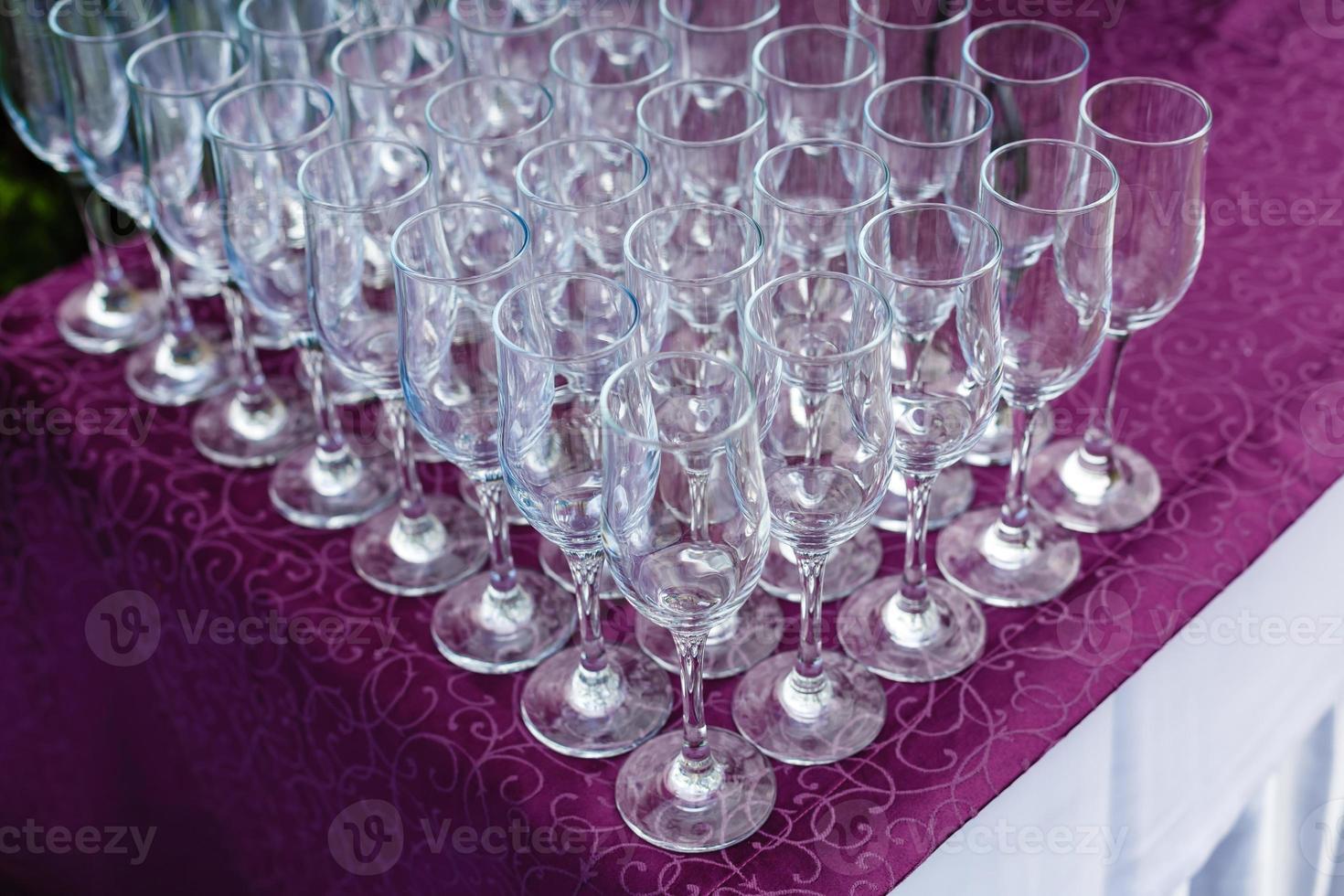 Beautiful champagne glasses defocused on buffet table in restaurant and blurred background photo