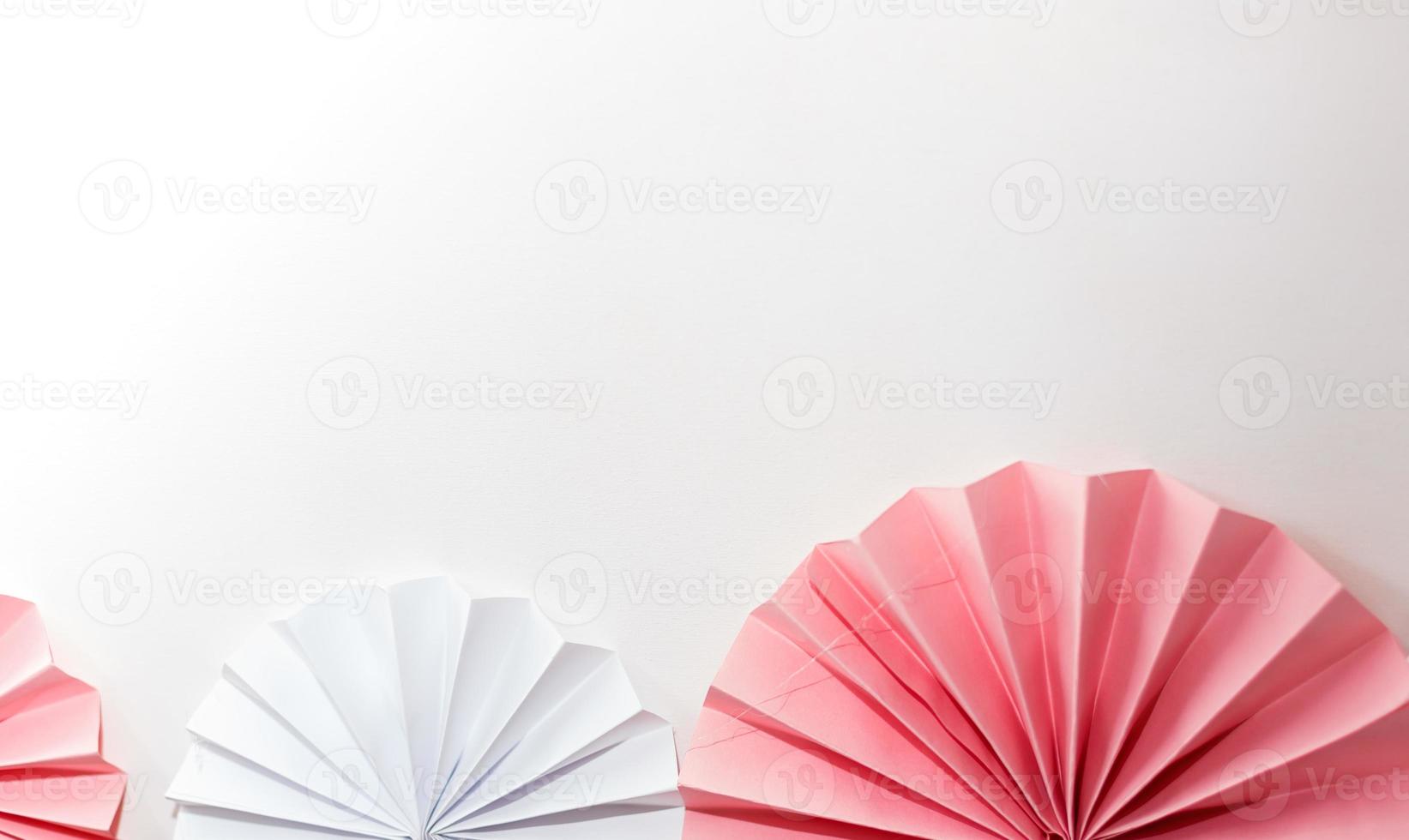 Pink and white striped paper fans photo