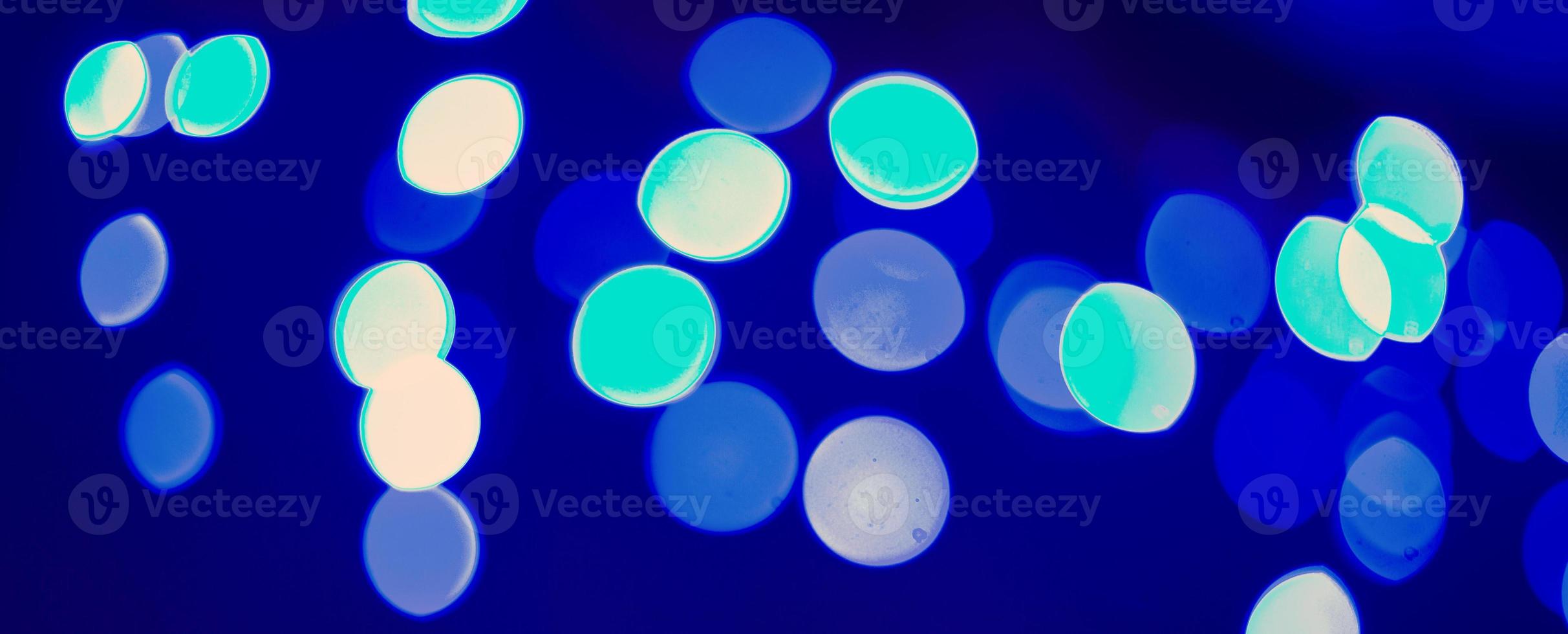 Digitally Generated Image of blue light on black background photo