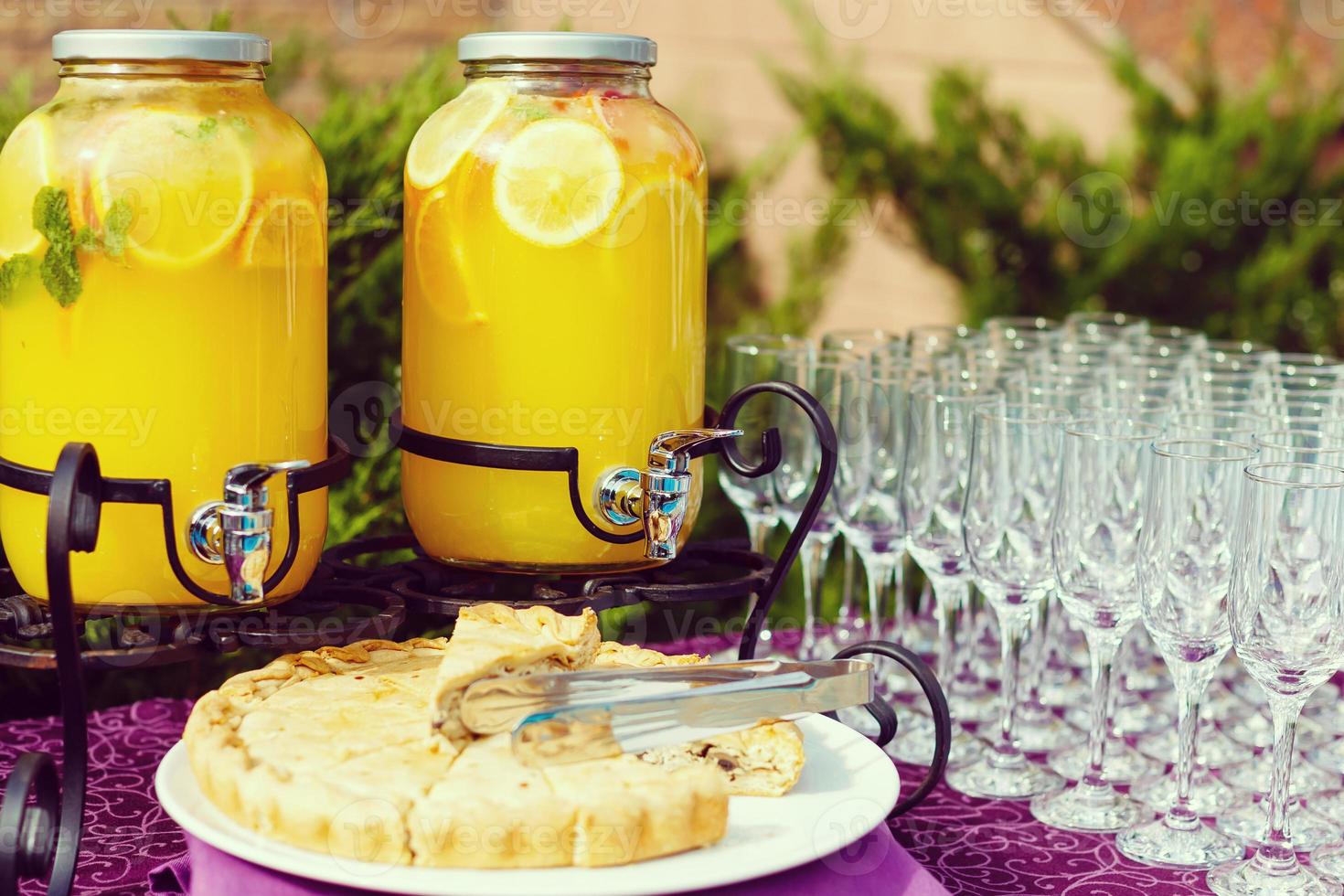Bank of lemonade with citrus fruits on a buffet table photo