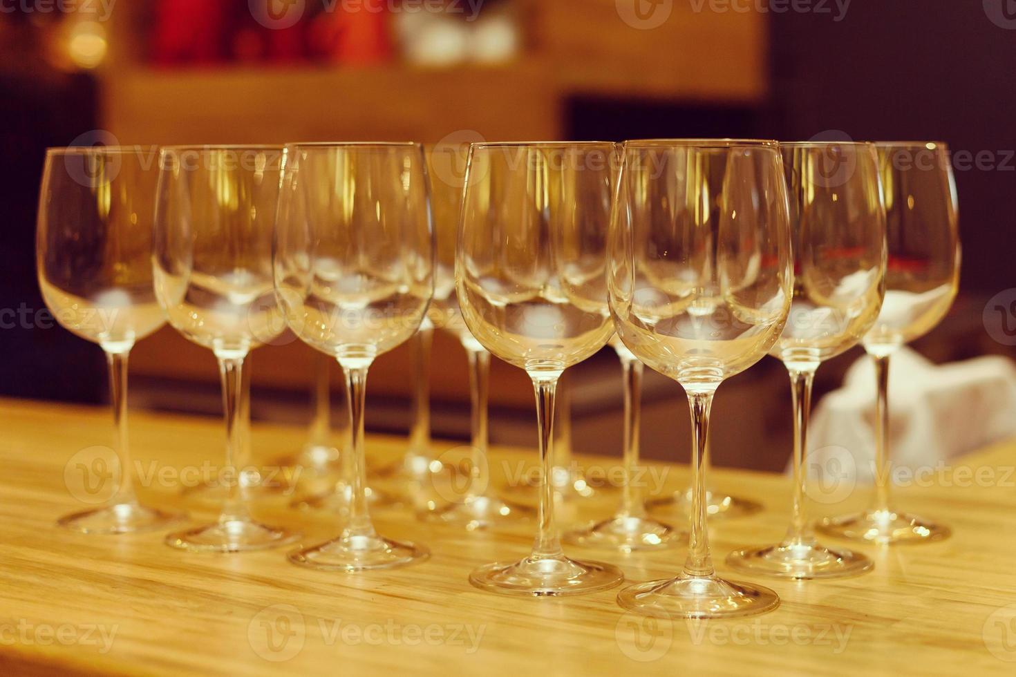 Wine glasses in row on bar photo