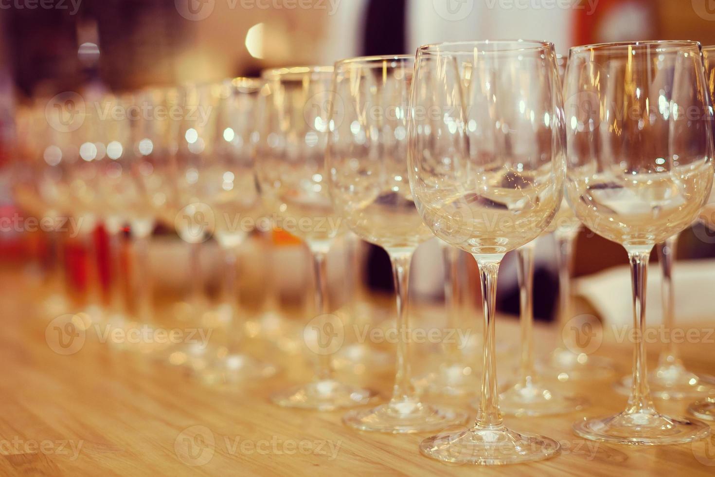 Wine glasses in row on bar photo