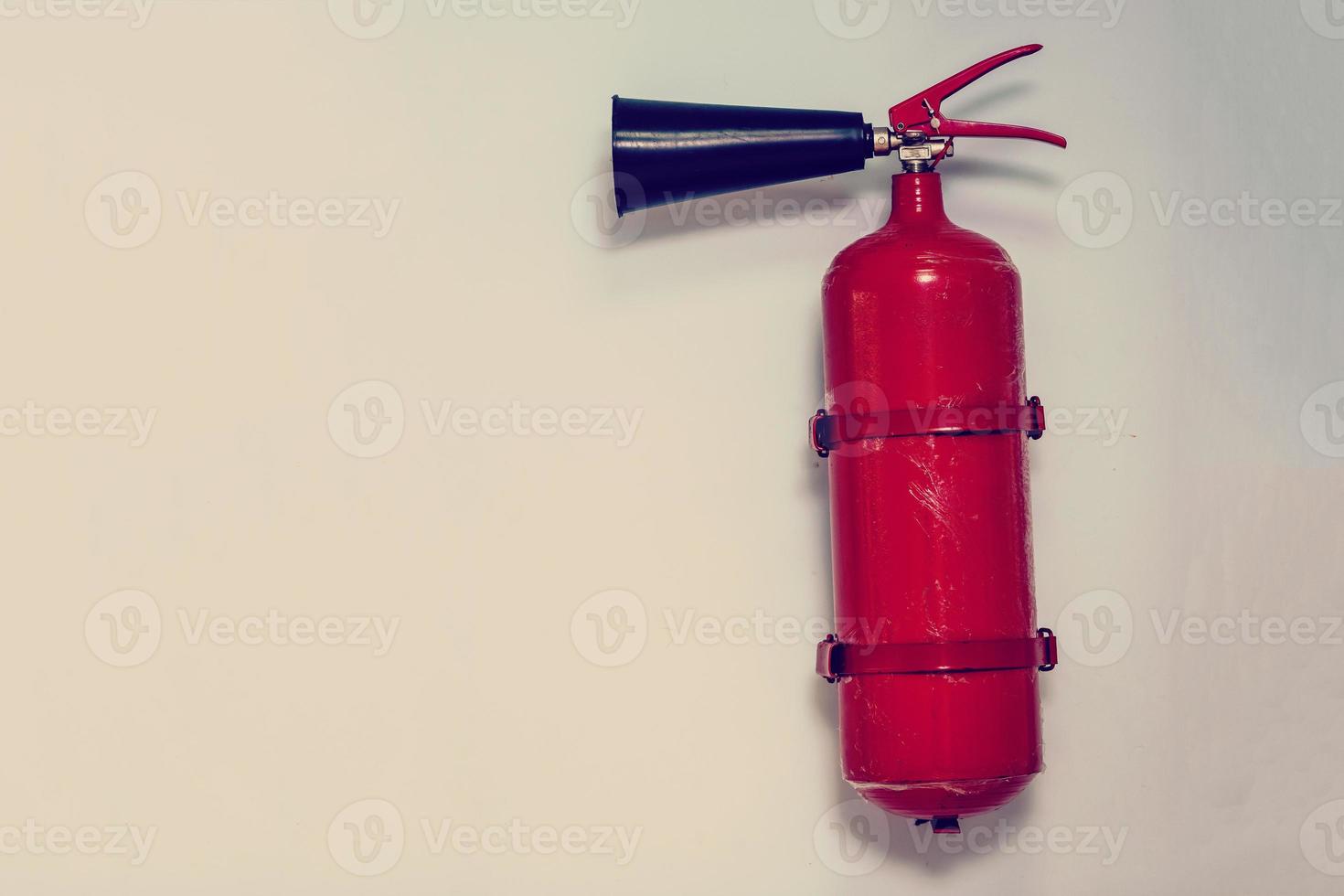 Fire extinguisher on the gray wall photo