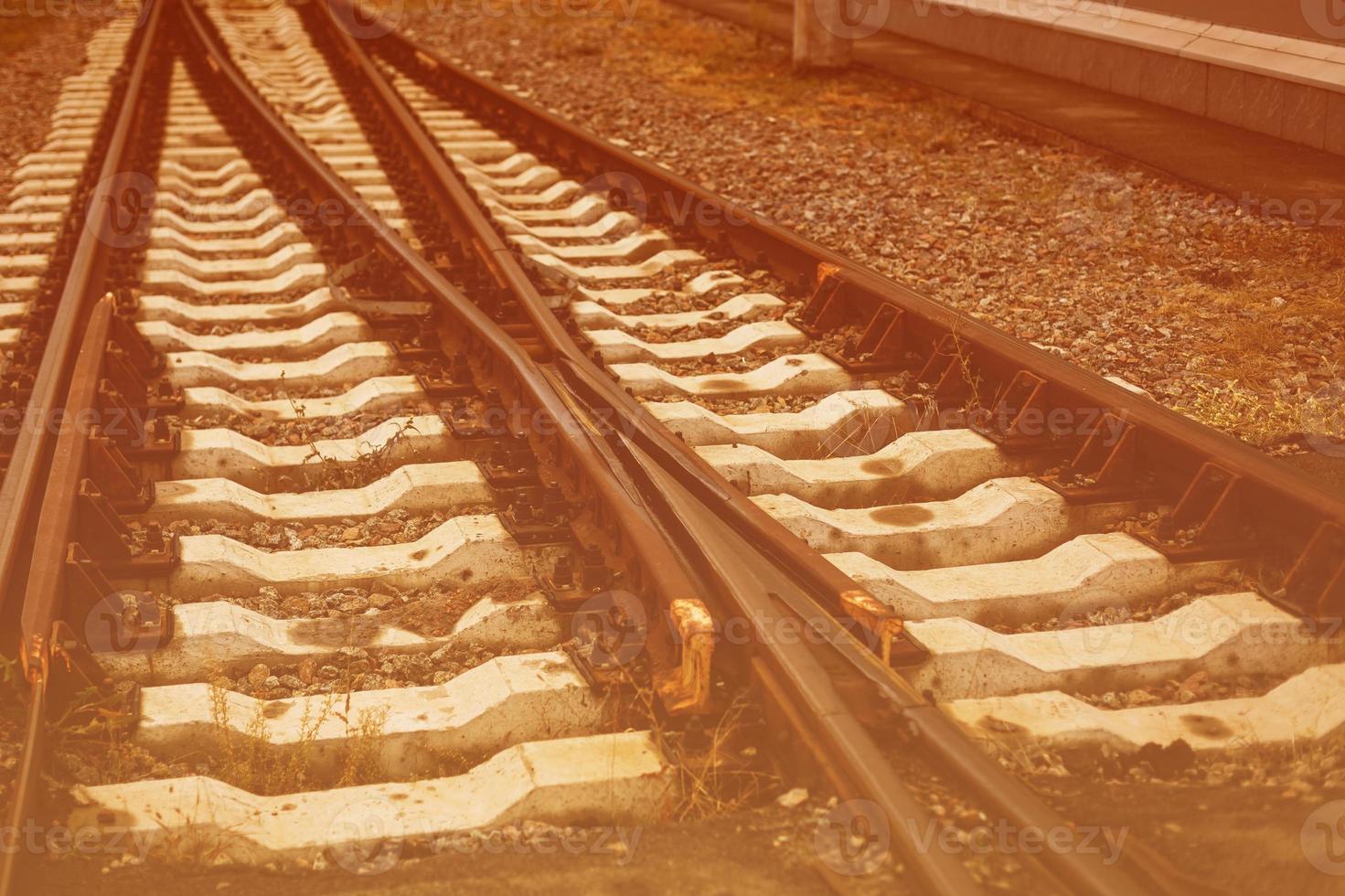 Two railway tracks merge photo